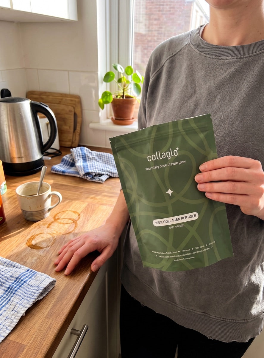 CollaGlo collagen peptides pouch held in a kitchen